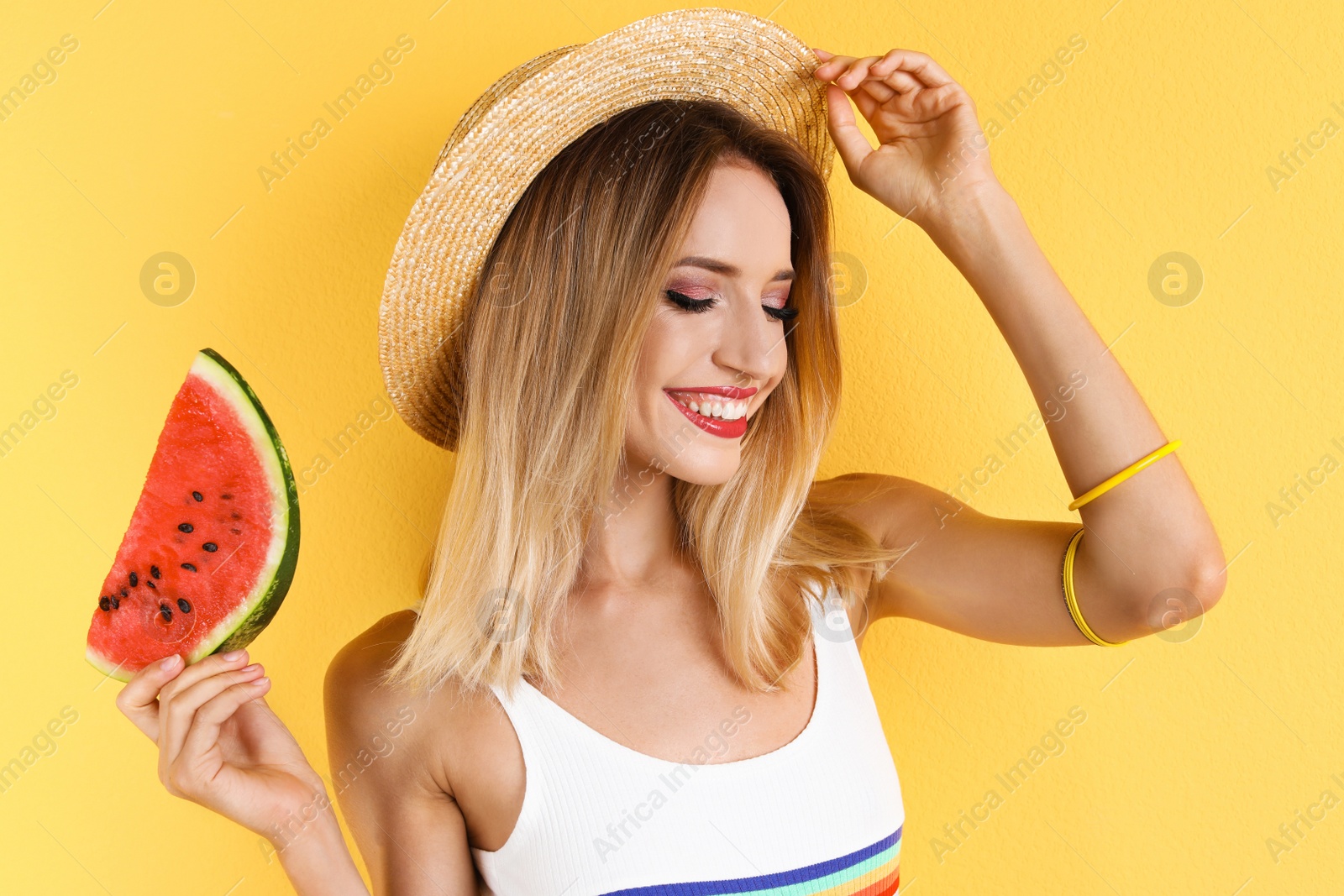 Photo of Pretty young woman with juicy watermelon on color background