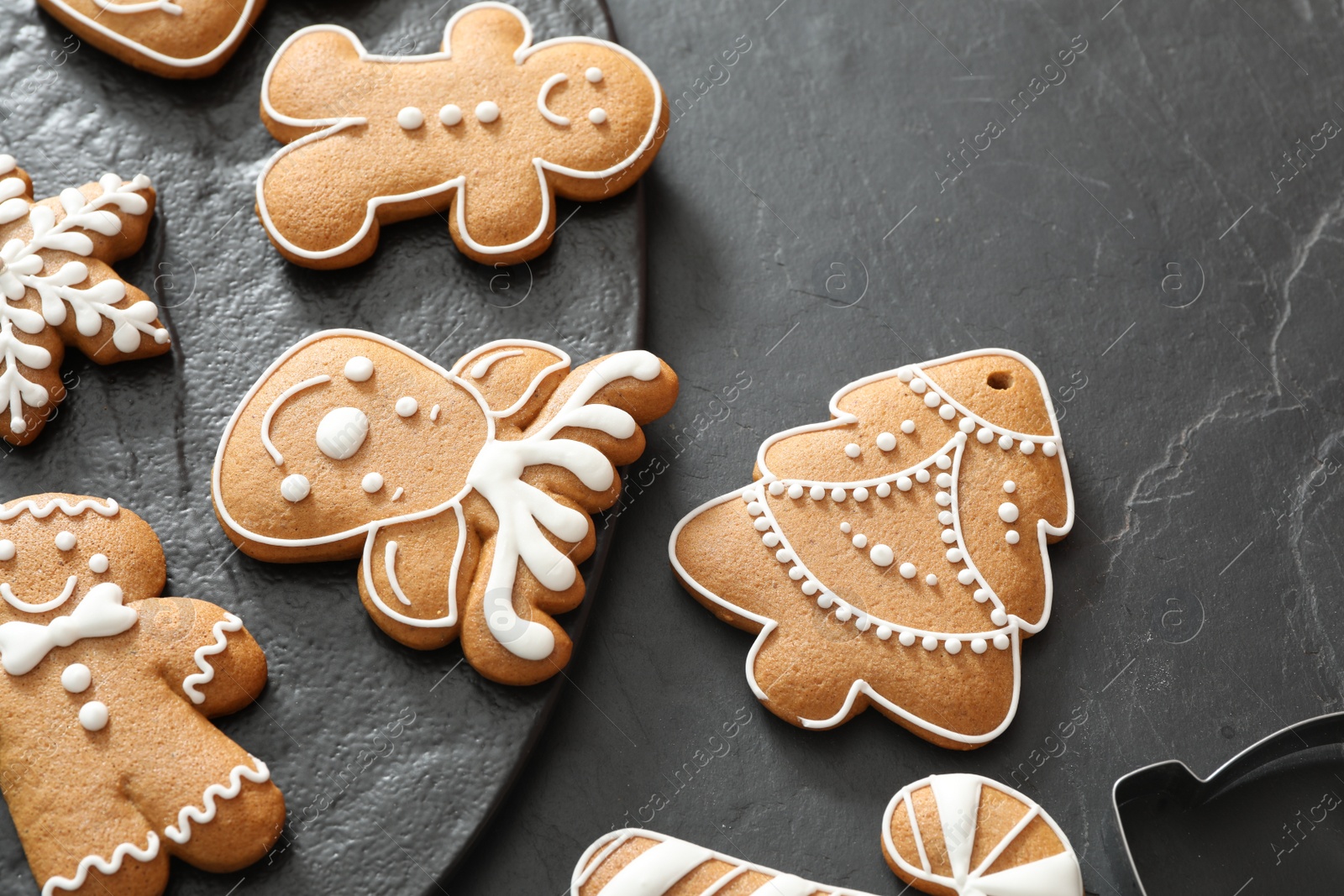 Photo of Delicious homemade Christmas cookies on black table, above view