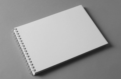 Blank notebook on light grey background. Mockup for design