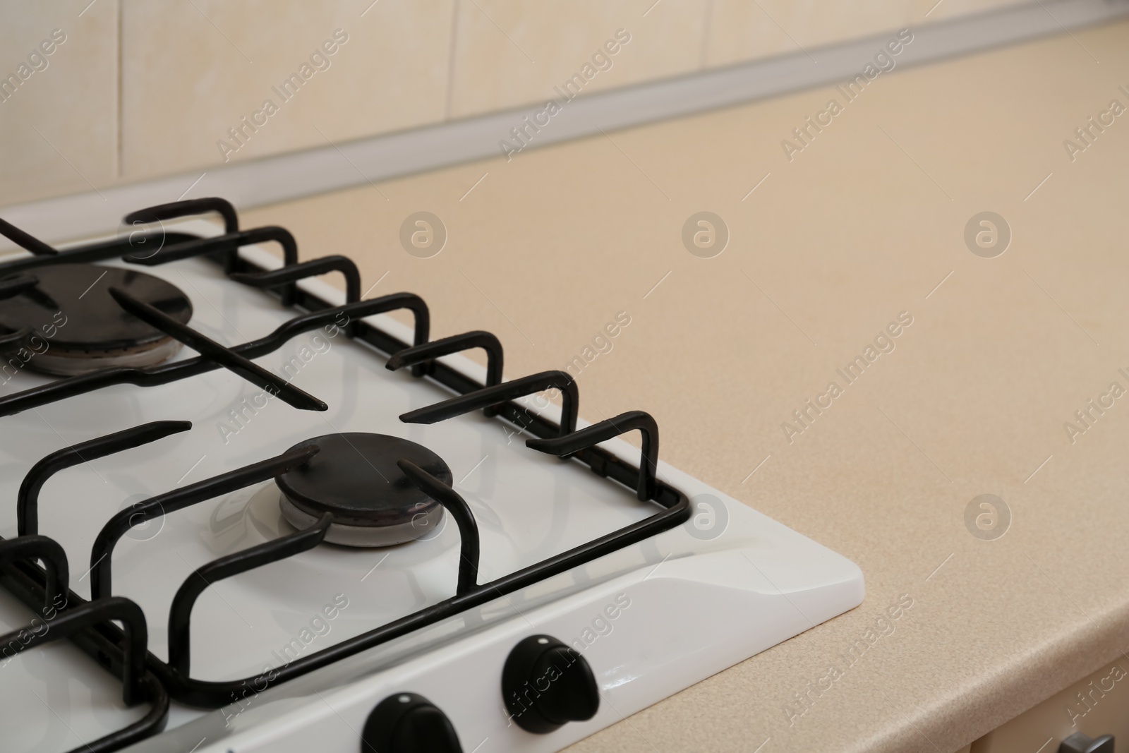 Photo of Modern gas cooktop in kitchen, closeup. Space for text