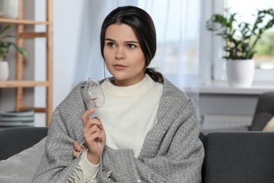 Photo of Sick young woman with nebulizer at home