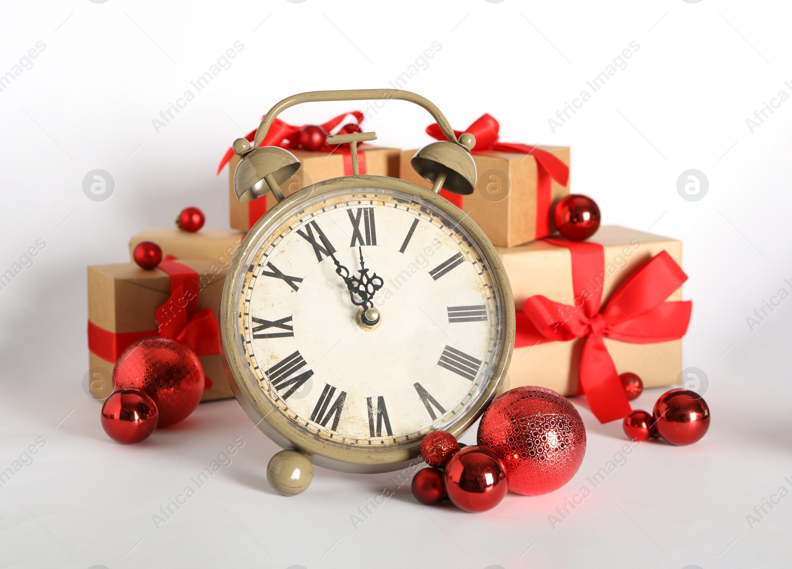 Photo of Vintage alarm clock with Christmas decor on white background. New Year countdown