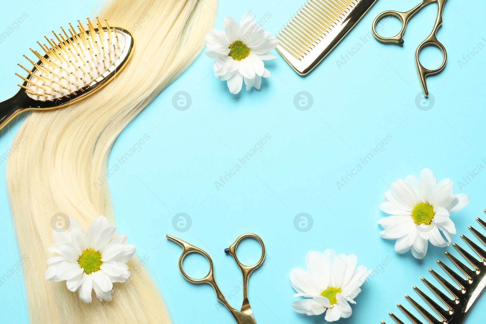 Photo of Flat lay composition with professional hairdresser tools, flowers and blonde hair strand on light blue background