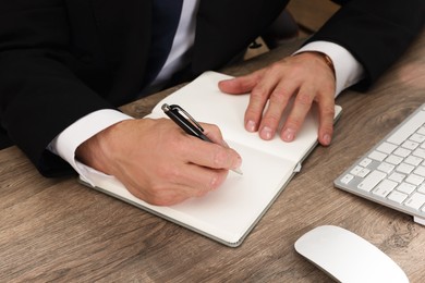 Boss working at wooden table indoors, closeup