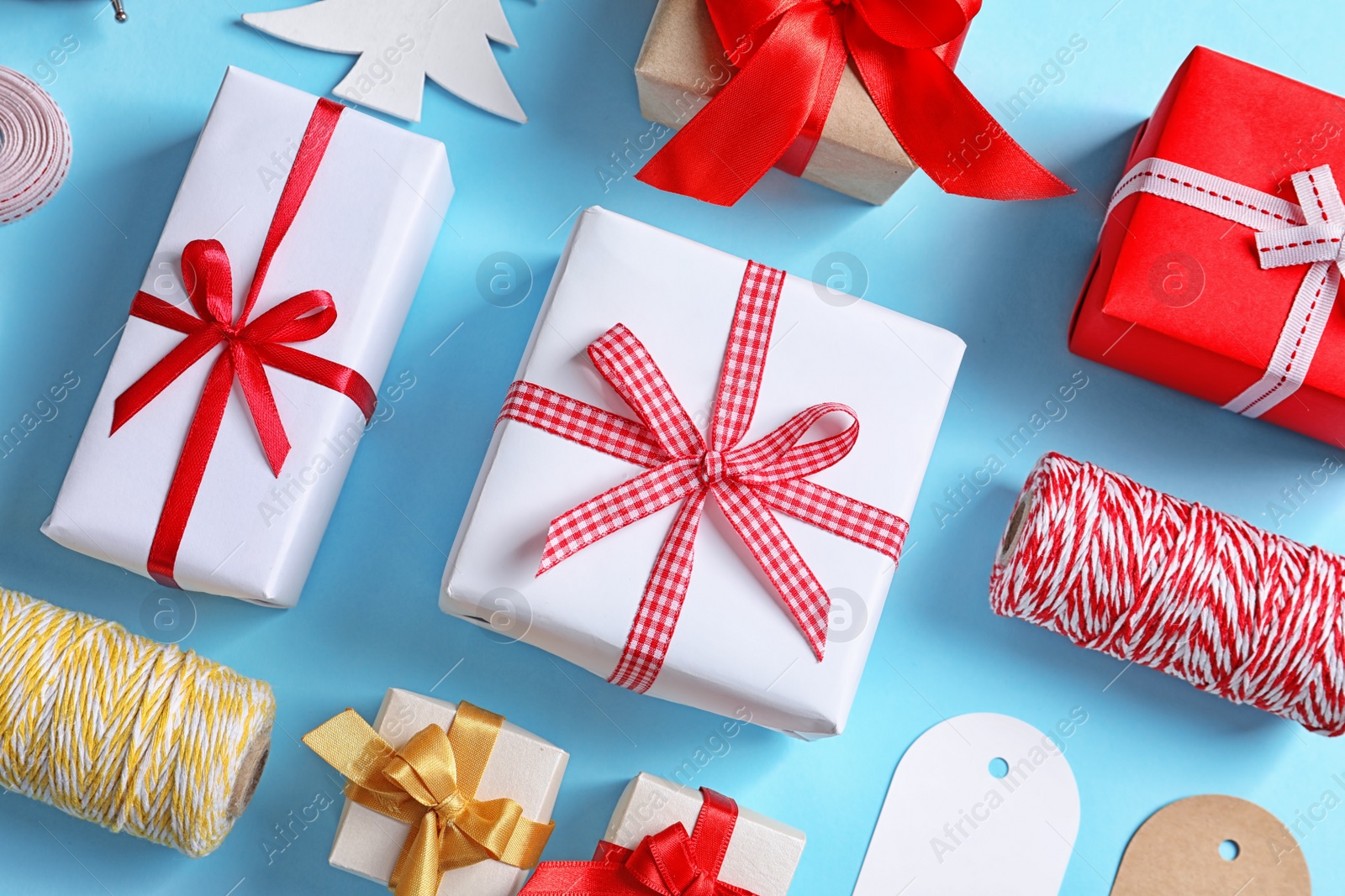 Photo of Flat lay composition with gift boxes on color background, top view