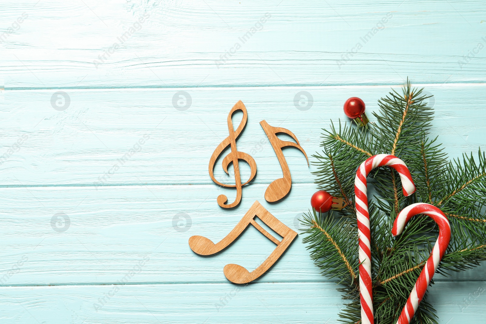 Photo of Flat lay composition with decorations and  notes on wooden background. Christmas music concept