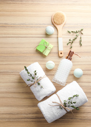 Photo of Flat lay composition with soap dispenser on wooden background