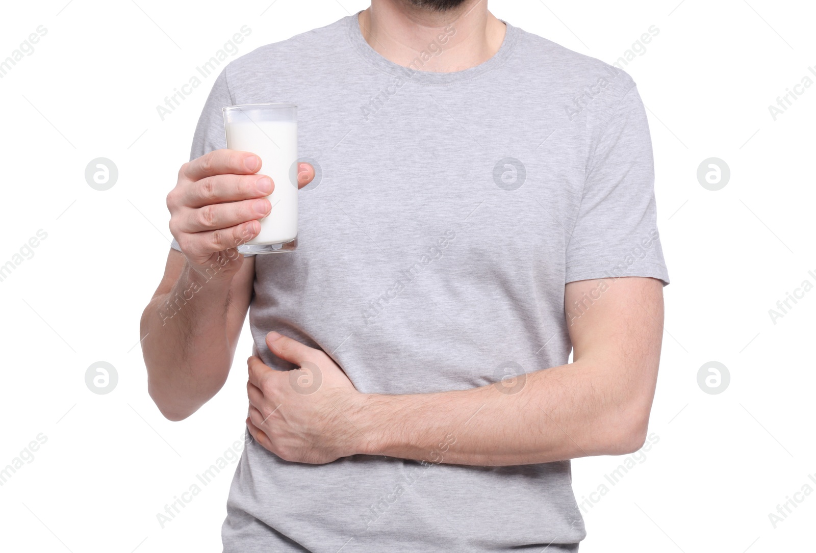 Photo of Man with glass of milk suffering from lactose intolerance on white background, closeup