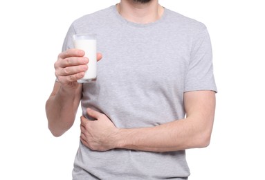 Man with glass of milk suffering from lactose intolerance on white background, closeup