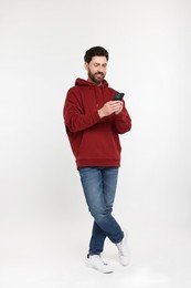 Photo of Happy man with smartphone on white background