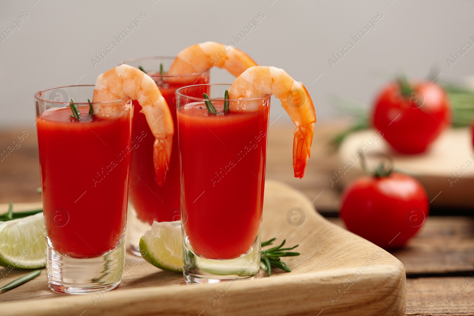 Photo of Shrimp cocktail with tomato sauce served on wooden table