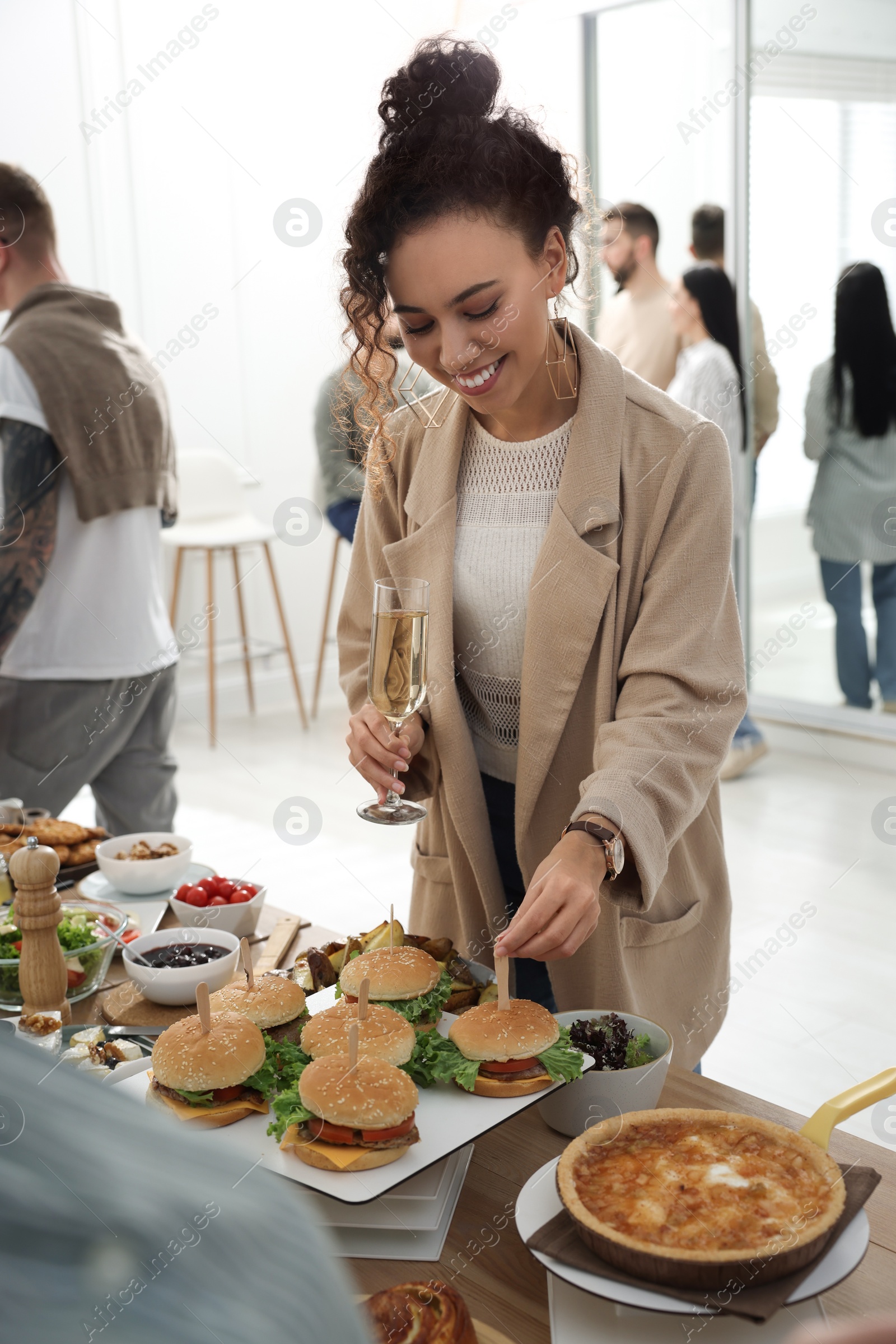 Photo of Young African American woman enjoying brunch buffet indoors