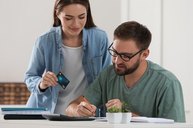 Young couple discussing family budget at home