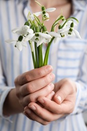 Woman holding beautiful bouquet of snowdrops, closeup