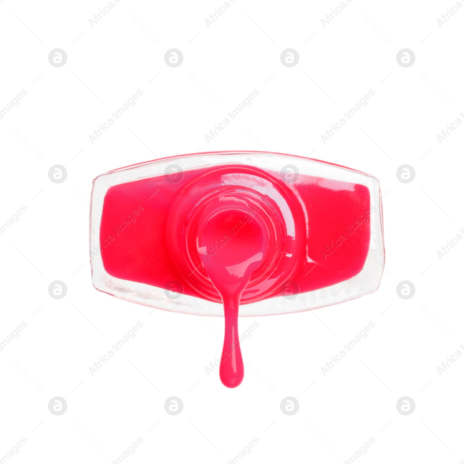Photo of Pink nail polish dripping from bottle isolated on white
