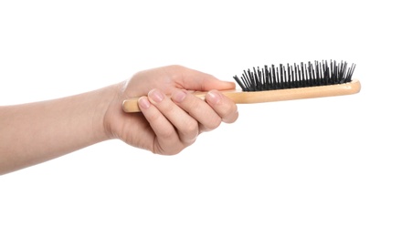 Photo of Woman holding hair brush on white background, closeup