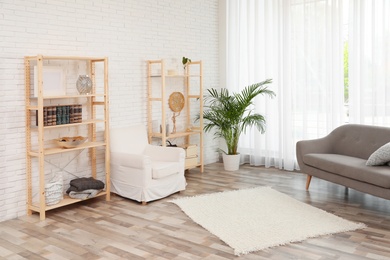 Photo of Wooden storage in stylish living room. Idea for interior design