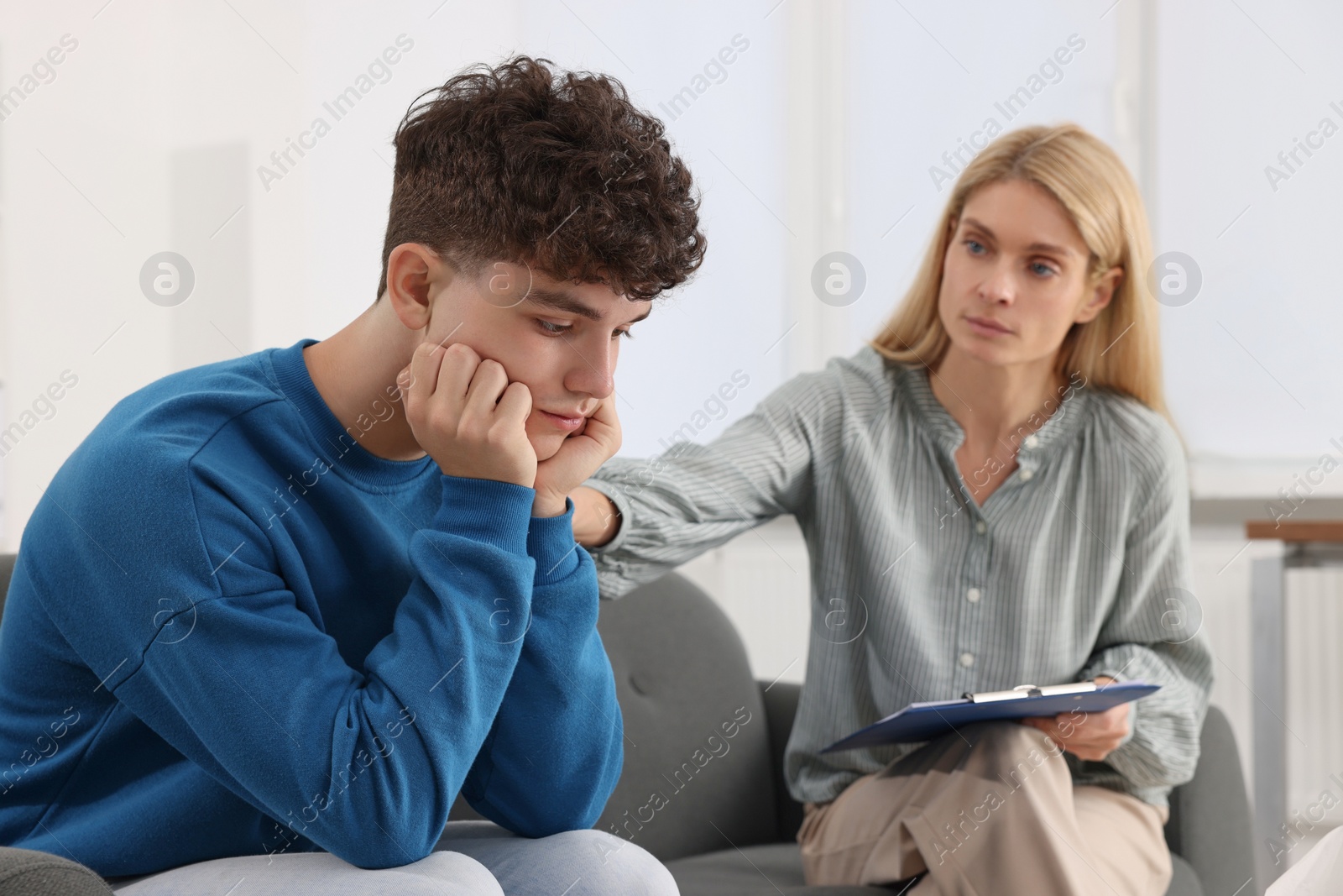 Photo of Psychologist working with teenage boy in office. Teenager problems