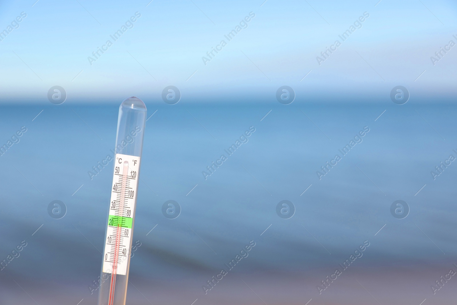 Photo of Weather thermometer at seaside, space for text