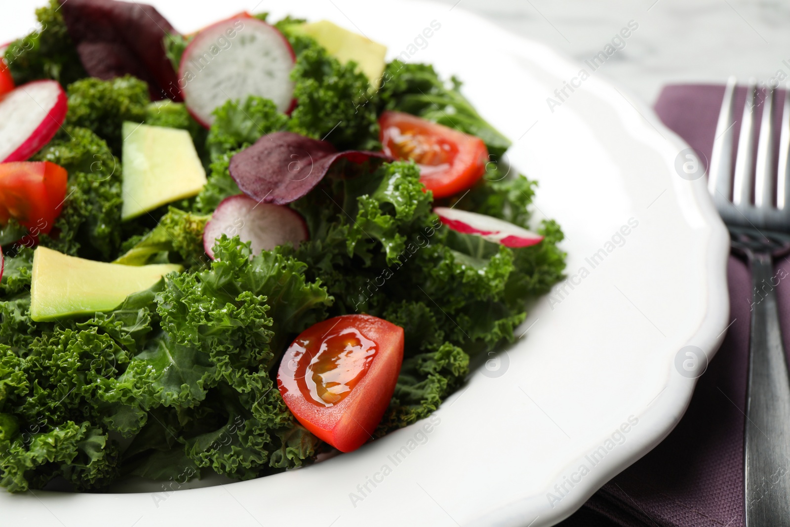 Photo of Delicious salad with kale leaves on table, closeup