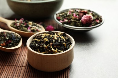 Photo of Different herbal teas on grey table, closeup