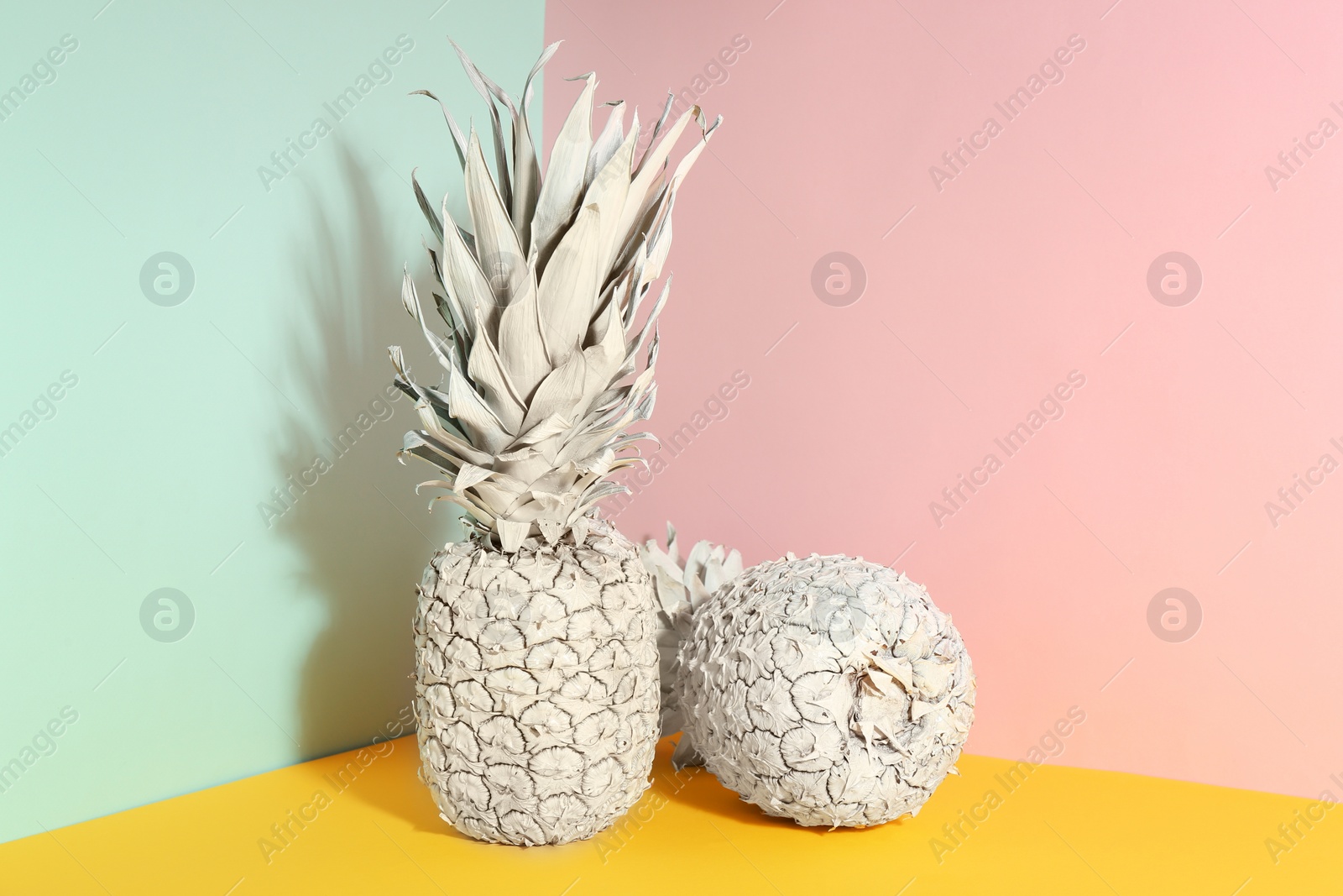 Photo of White pineapples on color background, space for text. Creative concept