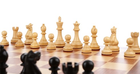 Set of chess pieces on wooden board against white background