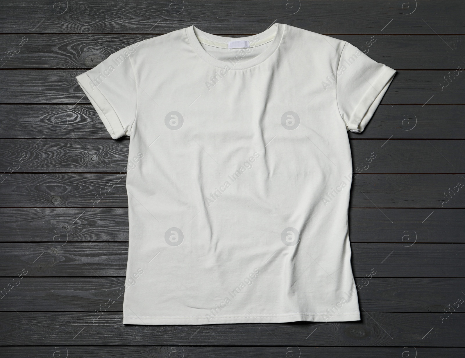 Photo of Stylish white T-shirt on gray wooden table, top view