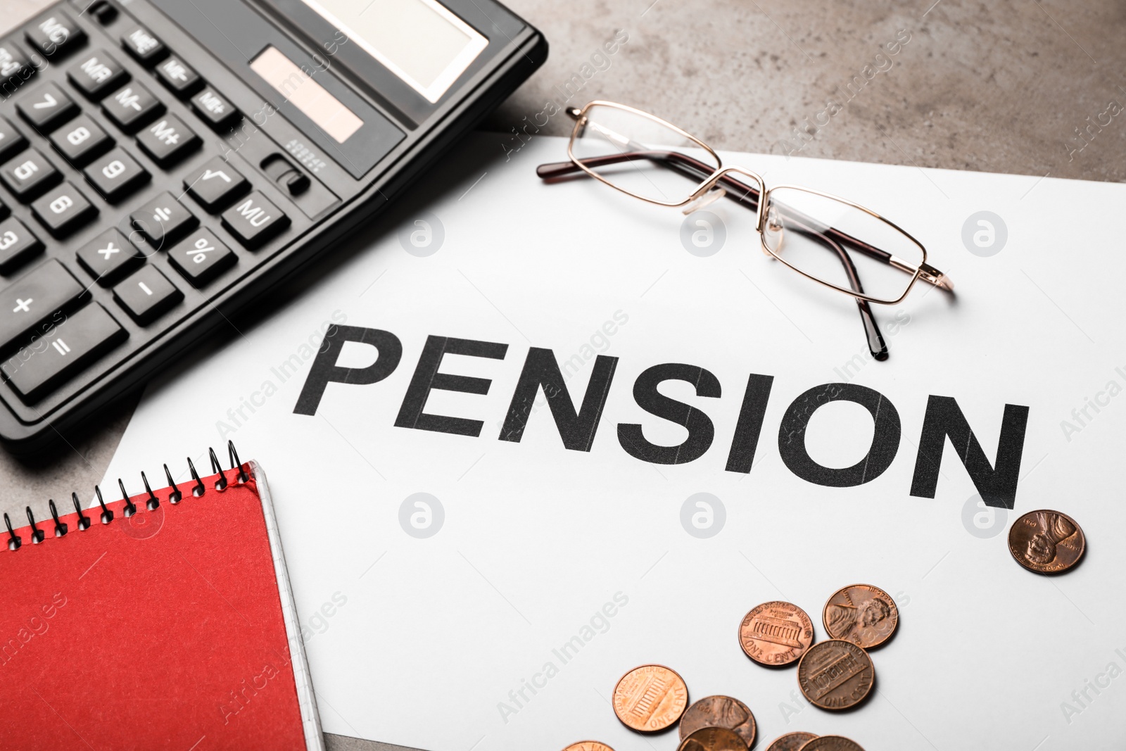 Photo of Paper with word PENSION, glasses, calculator and money on table