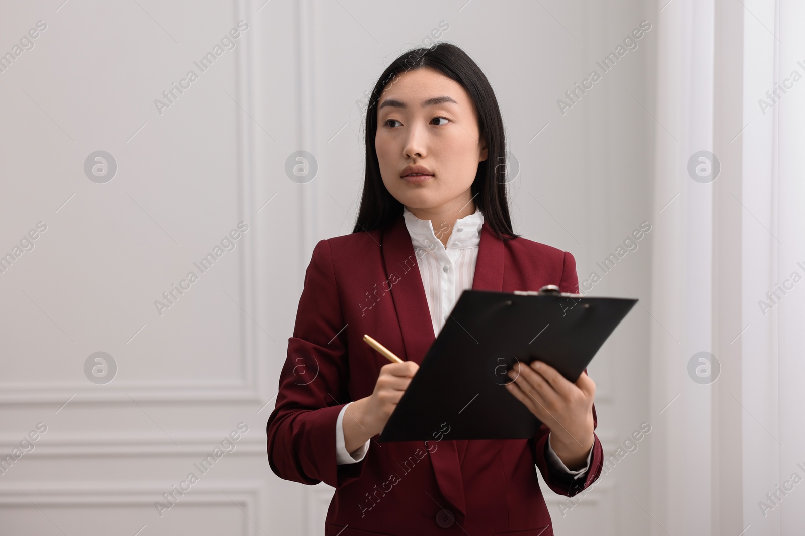 Photo of Portrait of notary with clipboard in office. Space for text