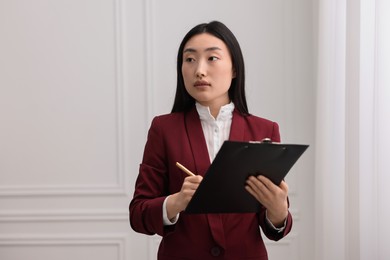 Portrait of notary with clipboard in office. Space for text