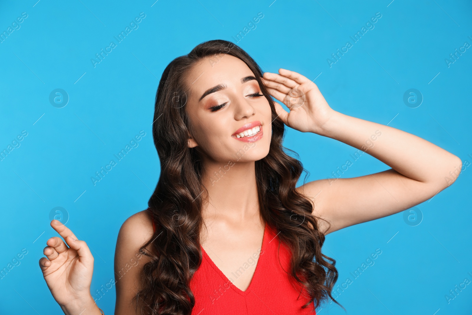 Photo of Beautiful young woman on blue background. Christmas party