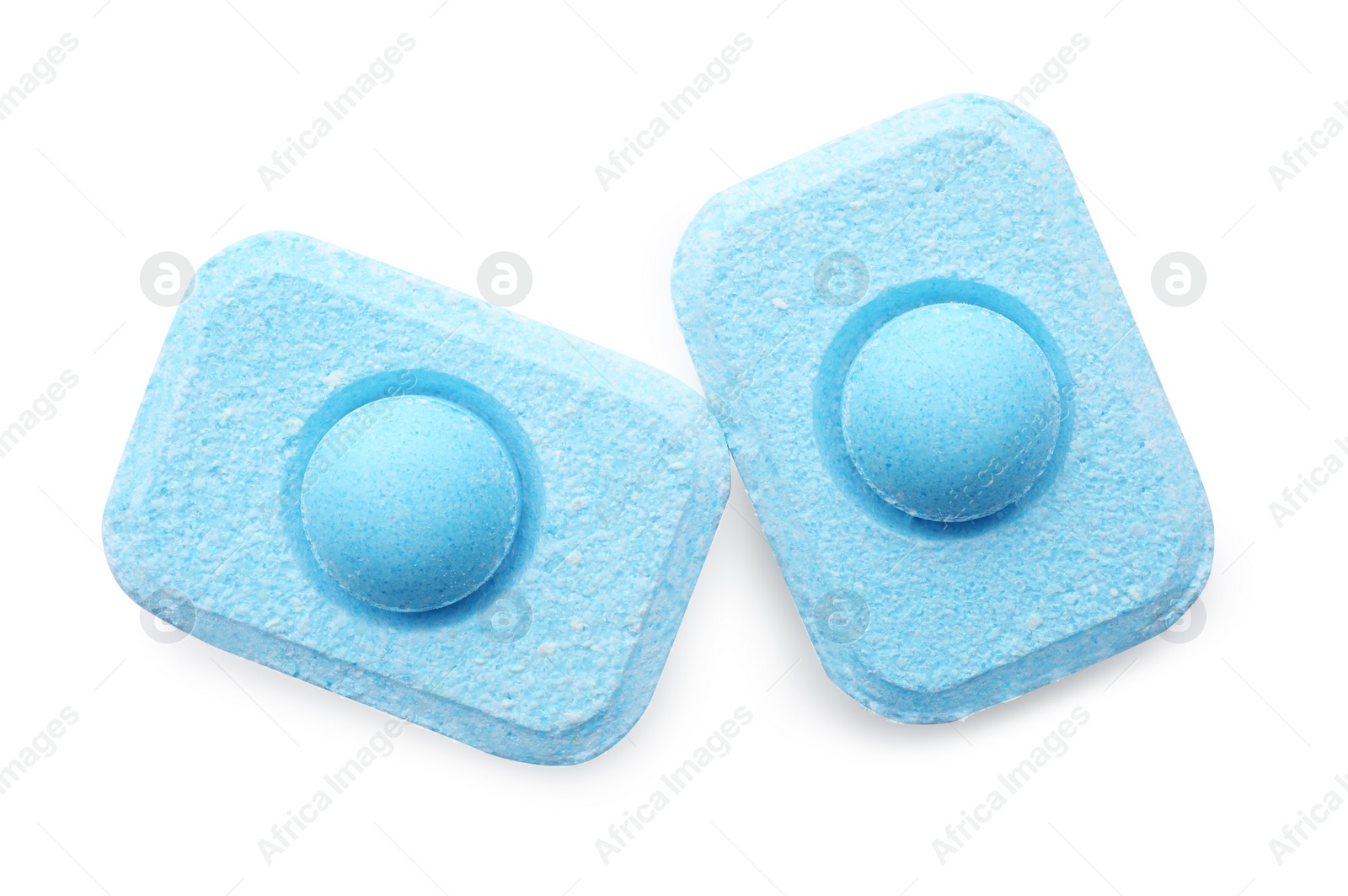 Photo of Two water softener tablets on white background