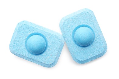 Two water softener tablets on white background