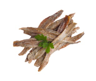 Photo of Heap of delicious anchovy fillets with parsley on white background, top view