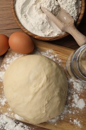 Cooking scones with soda water. Dough and ingredients on wooden table, flat lay