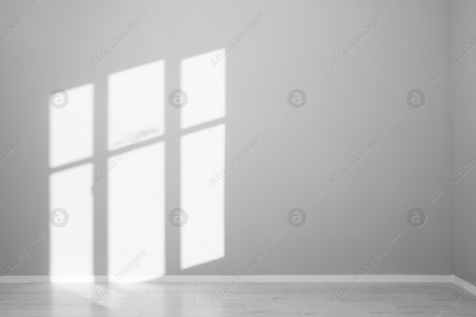 Photo of Light and shadows from window on wall indoors