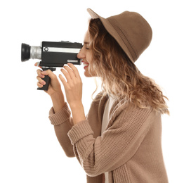 Beautiful young woman using vintage video camera on white background