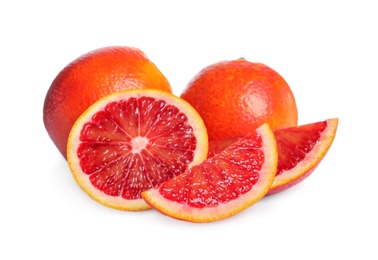 Photo of Whole and cut red oranges on white background