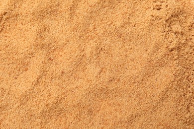 Photo of Brown coconut sugar as background, top view