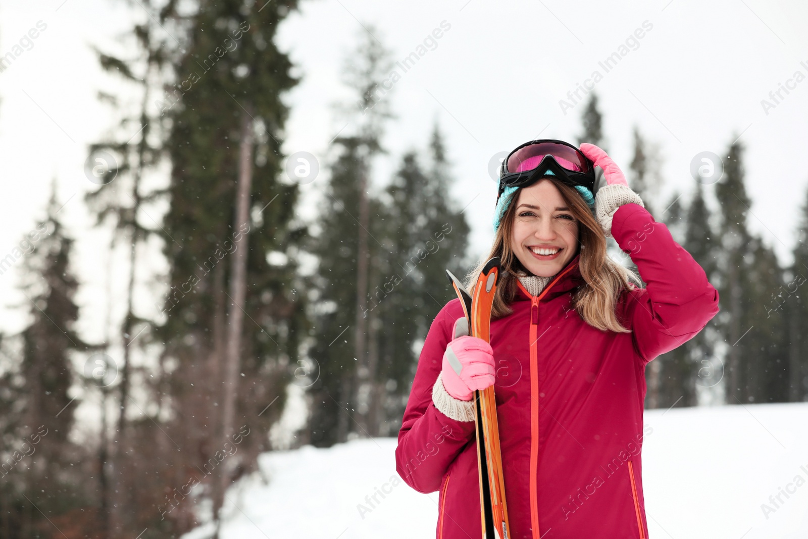 Photo of Female skier on slope at resort, space for text. Winter vacation