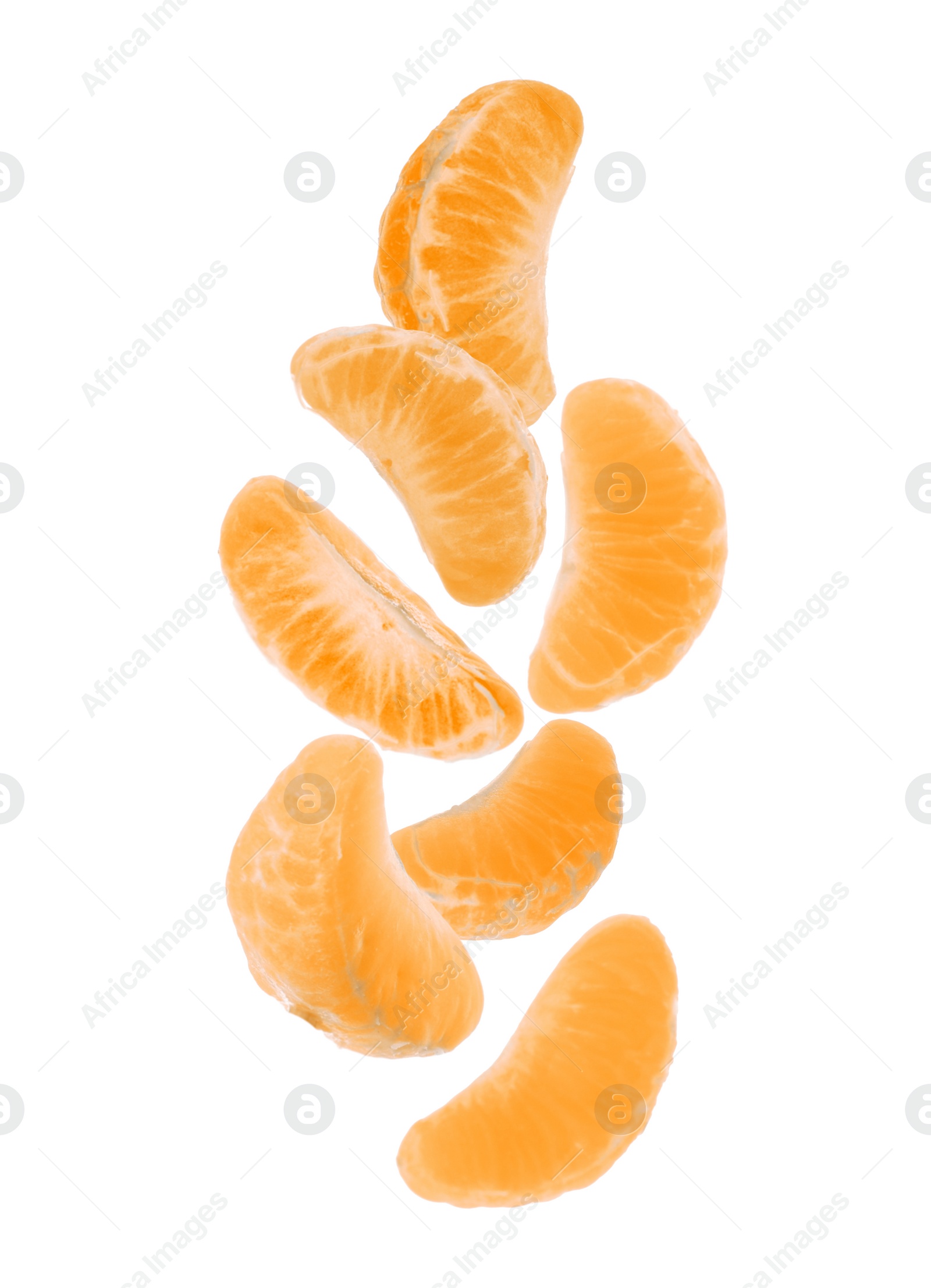 Image of Pieces of tasty tangerine falling on white background