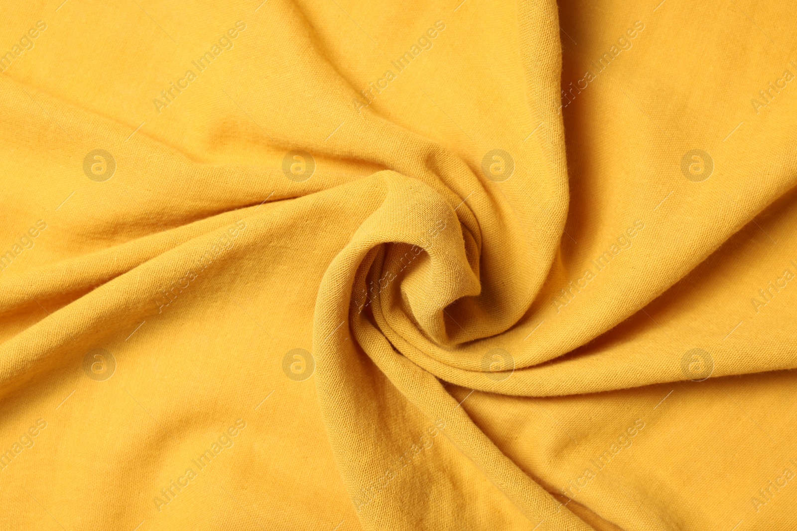 Photo of Texture of soft yellow crumpled fabric as background, top view