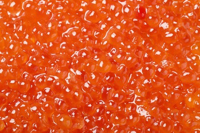 Photo of Delicious red caviar as background, top view