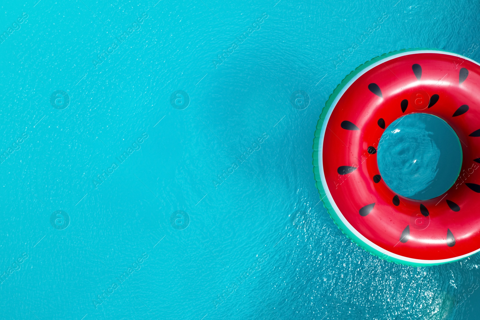 Image of Top view of inflatable ring floating in swimming pool, space for text. Summer vacation