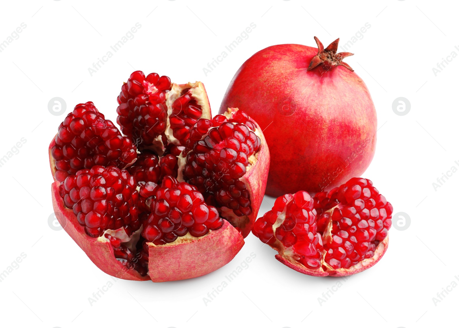 Photo of Whole and cut fresh pomegranates isolated on white