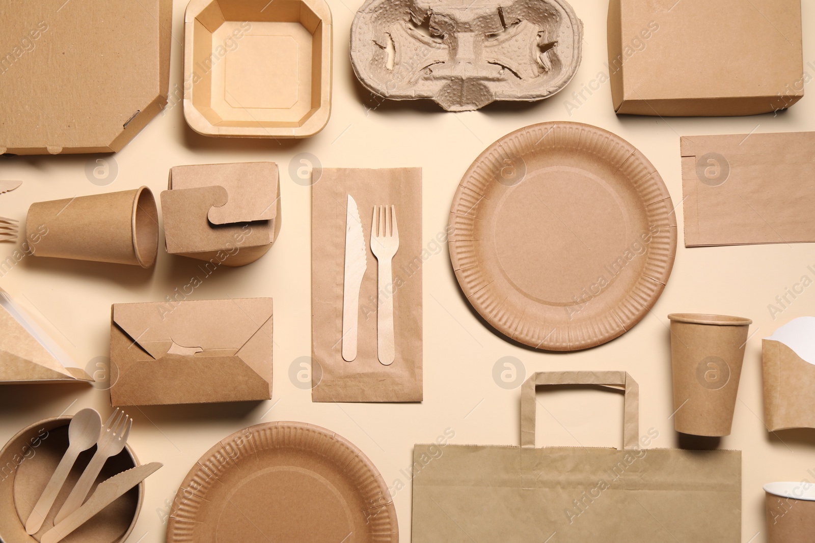 Photo of Flat lay composition with eco friendly food packagings on beige background