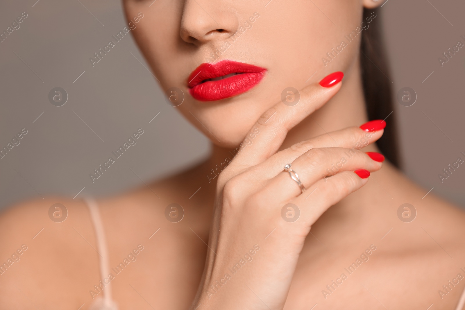 Photo of Beautiful young woman with bright manicure on color background, closeup. Nail polish trends