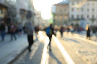 Photo of Blurred view of people walking on city street