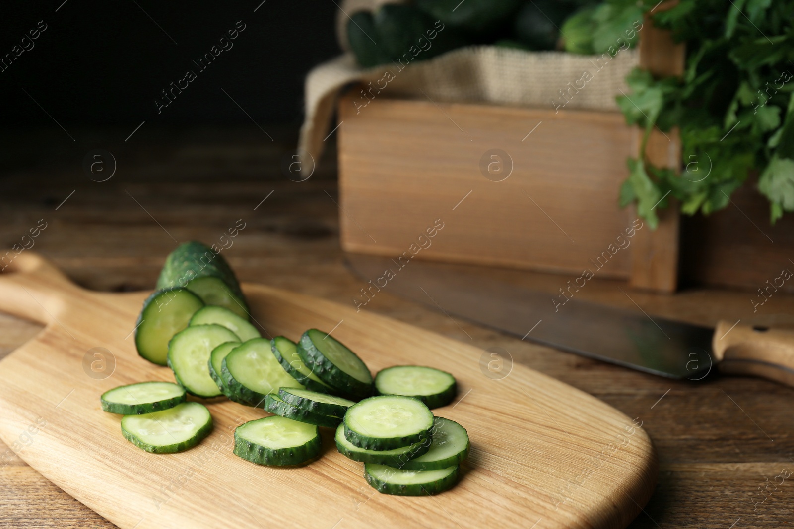 Photo of Slices of fresh ripe cucumber on wooden table